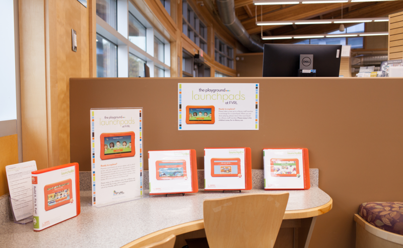 A table and chair set in the interior of Abbotsford Community Library, showcasing a cozy reading space.