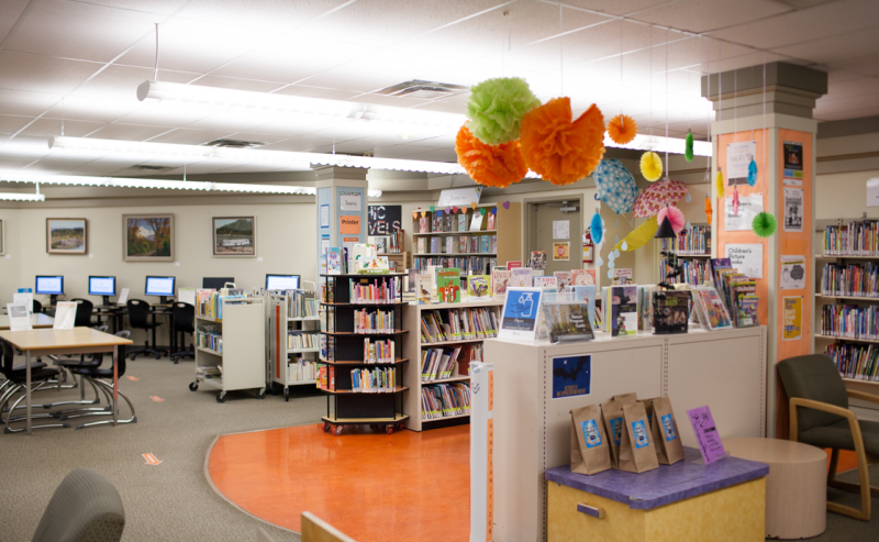 Inside Aldergrove Library, a cozy space filled with books and computers for reading and research.