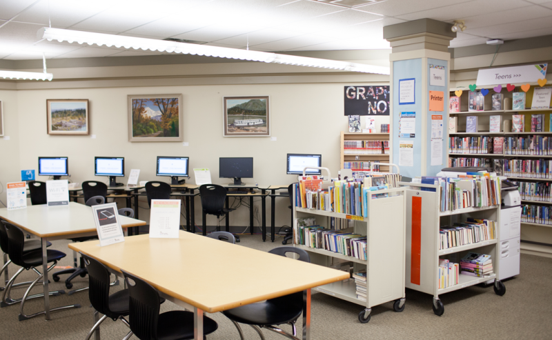 Interior of Aldergrove Library featuring shelves of books and computers for public use.