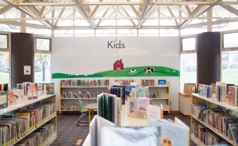 Interior of Chilliwack Library featuring shelves filled with a variety of books in the kids area of the library.