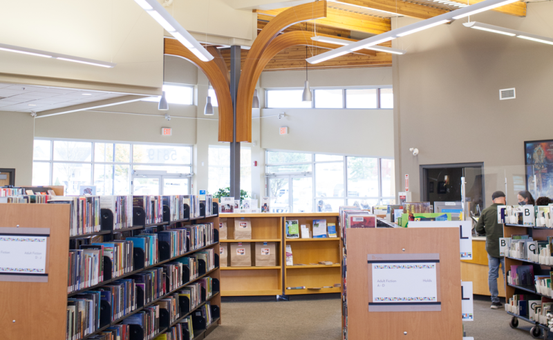 A vast interior of Sardis Library showcasing rows of books on shelves, creating a scholarly and inviting atmosphere.
