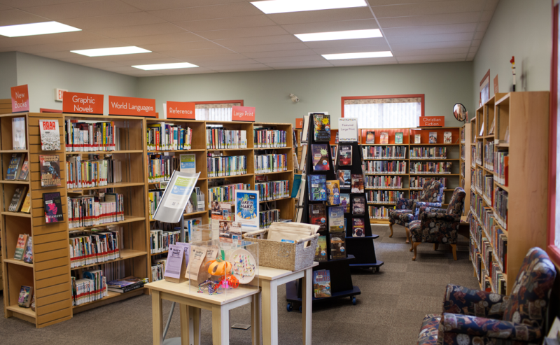 Yarrow Library's interior showcases extensive shelves brimming with books, creating a cozy reading atmosphere.