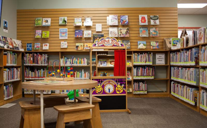 A wooden table and chair in Yarrow Library's children's area, providing a comfortable spot for reading and reflection.