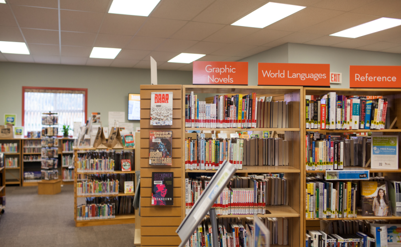 Inside Yarrow Library, a warm atmosphere with numerous books neatly arranged on shelves for visitors to browse.