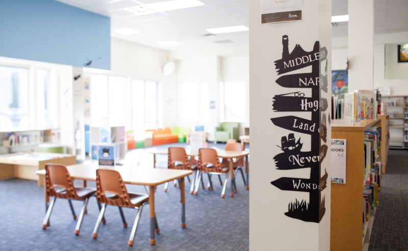 City of Langley Library interior showcasing chairs and informative signs on the walls.