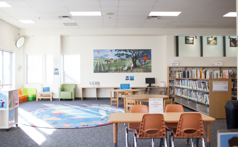 Interior view of the City of Langley Library showcasing a large table with multiple chairs in a roomy setting.