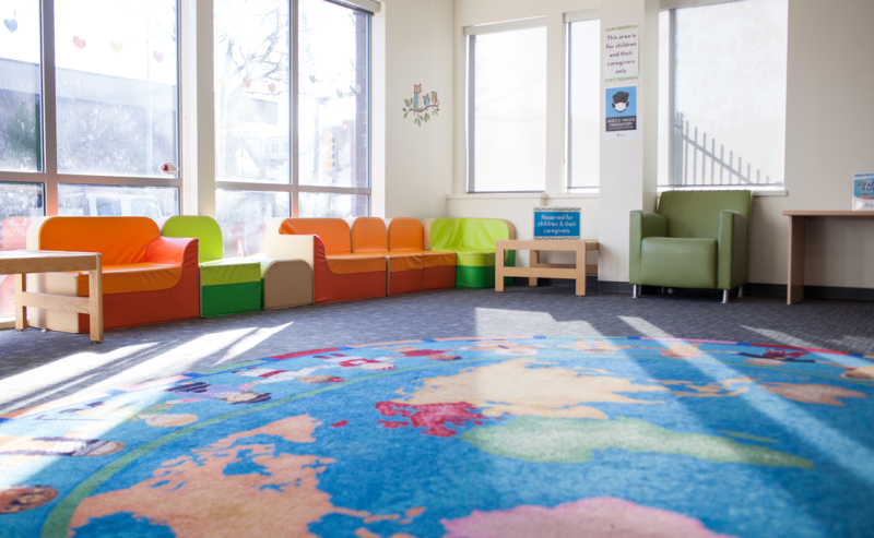 A bright, colorful rug decorates the floor in the cozy interior of the City of Langley Library.