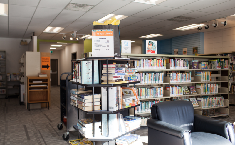 Brookswood Library's interior featuring rows of books on shelves, inviting readers to explore.