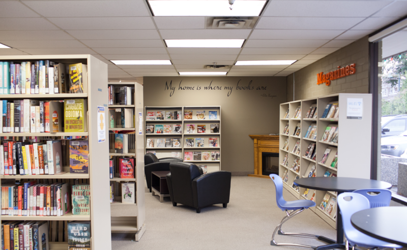  Interior view of Tsawwassen Library showcasing shelves filled with various books in a cozy reading environment.
