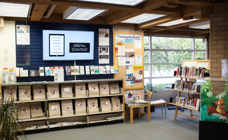 A large window in the Ladner Pioneer Library, allowing natural light to fill the room.