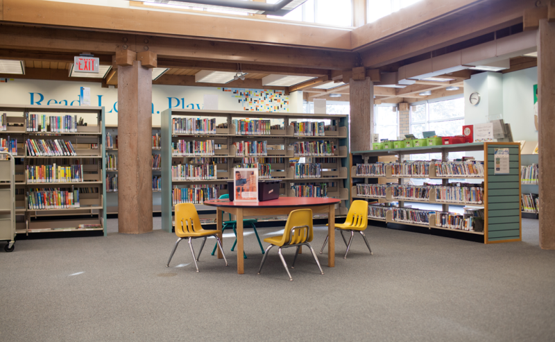 Inside Ladner Pioneer Library, a welcoming children's area with a table and chairs for reading and studying.