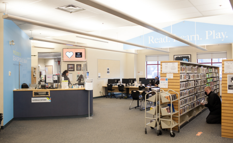 Inside Dean Drysdale Library, a man relaxes on a chair, immersed in the peaceful atmosphere of books.