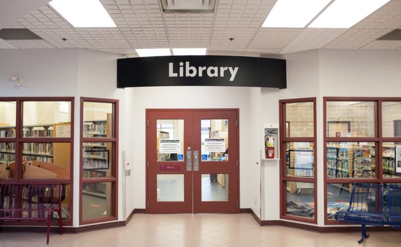 Exterior view of Dean Drysdale Library with open doors, inviting visitors to enter and explore its resources.