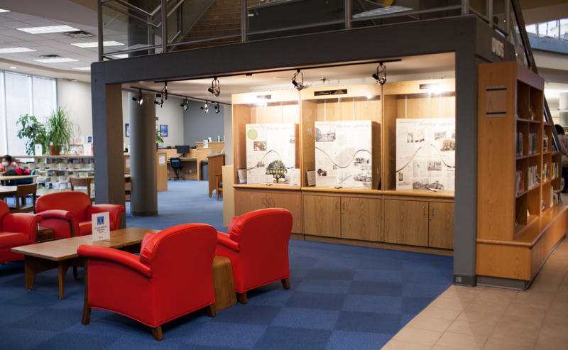 The interior of Maple Ridge Public Library features a blue carpet on the floor, with red chairs adding a vibrant touch.