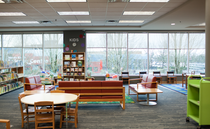 Interior of Maple Ridge Public Library featuring a spacious room filled with numerous chairs and tables for reading and studying.
