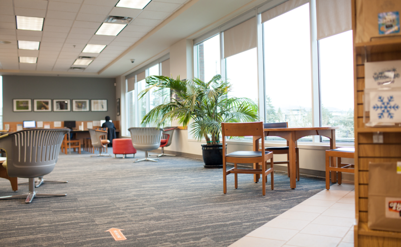 Maple Ridge Public Library's interior, displaying a vast area with an abundance of chairs and tables for visitors.