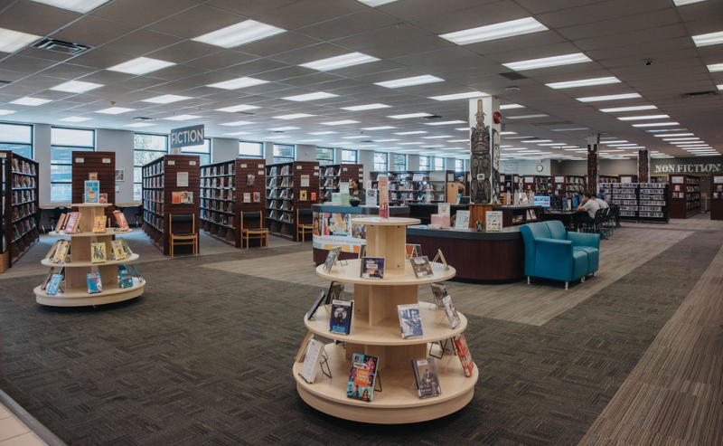 Interior of Mission Library featuring shelves of books and comfortable chairs for reading and studying.
