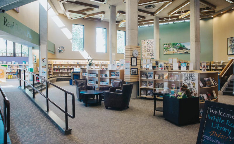 The White Rock Library's interior features extensive bookshelves brimming with a diverse array of books for visitors.