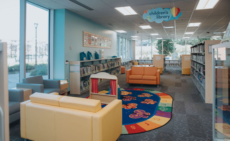 Terry Fox Library's interior showcases bright furniture and bookshelves, inviting visitors to explore and enjoy reading.