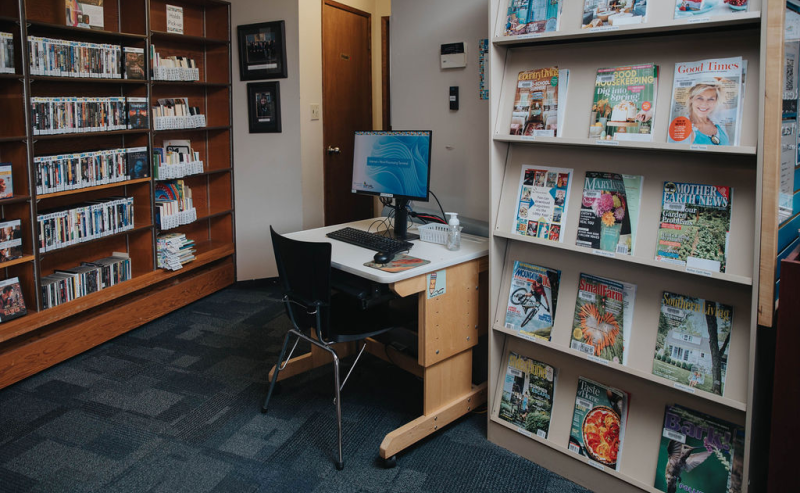 Inside Mount Lehman Library, shelves are stocked with a diverse collection of books and magazines.