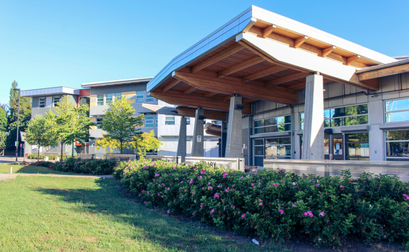 Exterior view of Abbotsford Community Library, showcasing its large building and distinctive roof design.