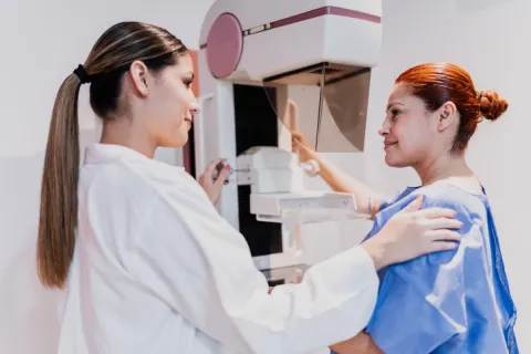 A doctor does a mammogram exam on a hospital patient.