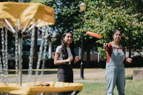 Teenage girls play Disc Golf from the FVRL Playground collection.