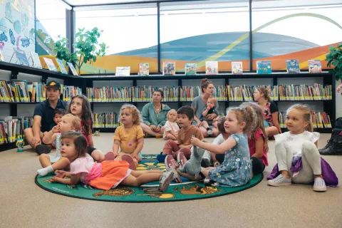 Tsawwassen Library: children and adults sit on the carpet during a Storytime program.