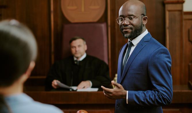 A courtroom scene with a trial judge and lawyer.