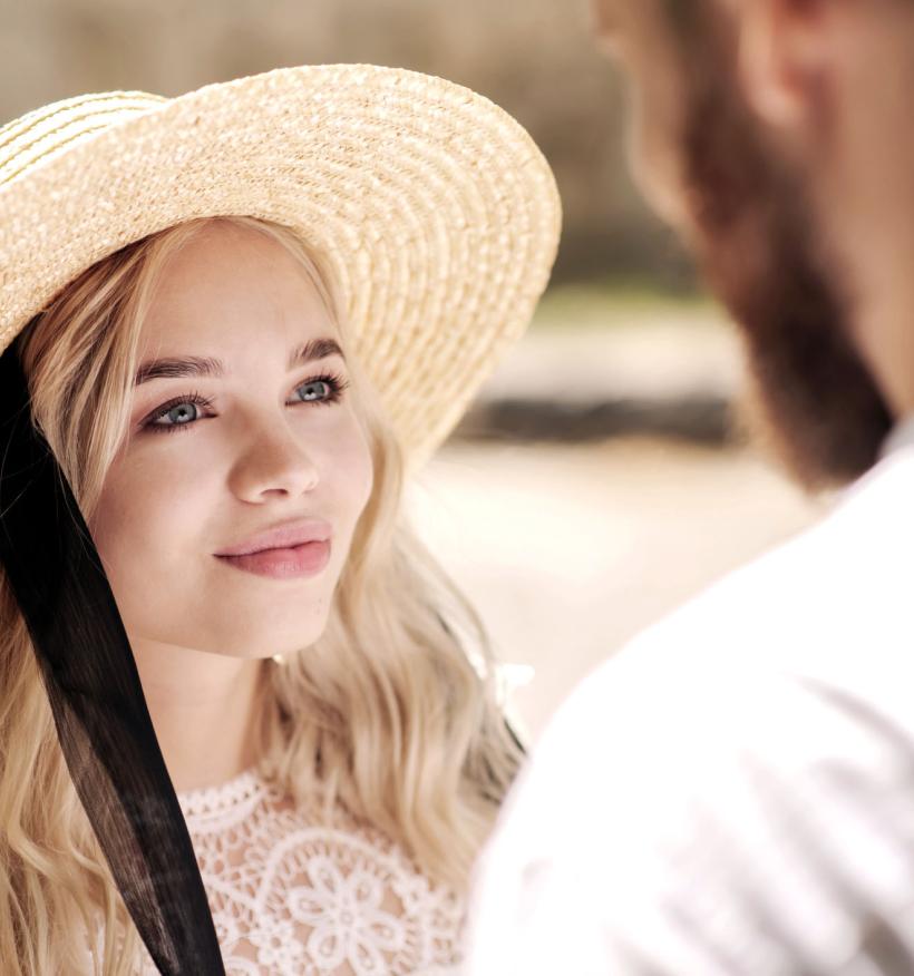 A happy couple look at each other with a loving gaze.